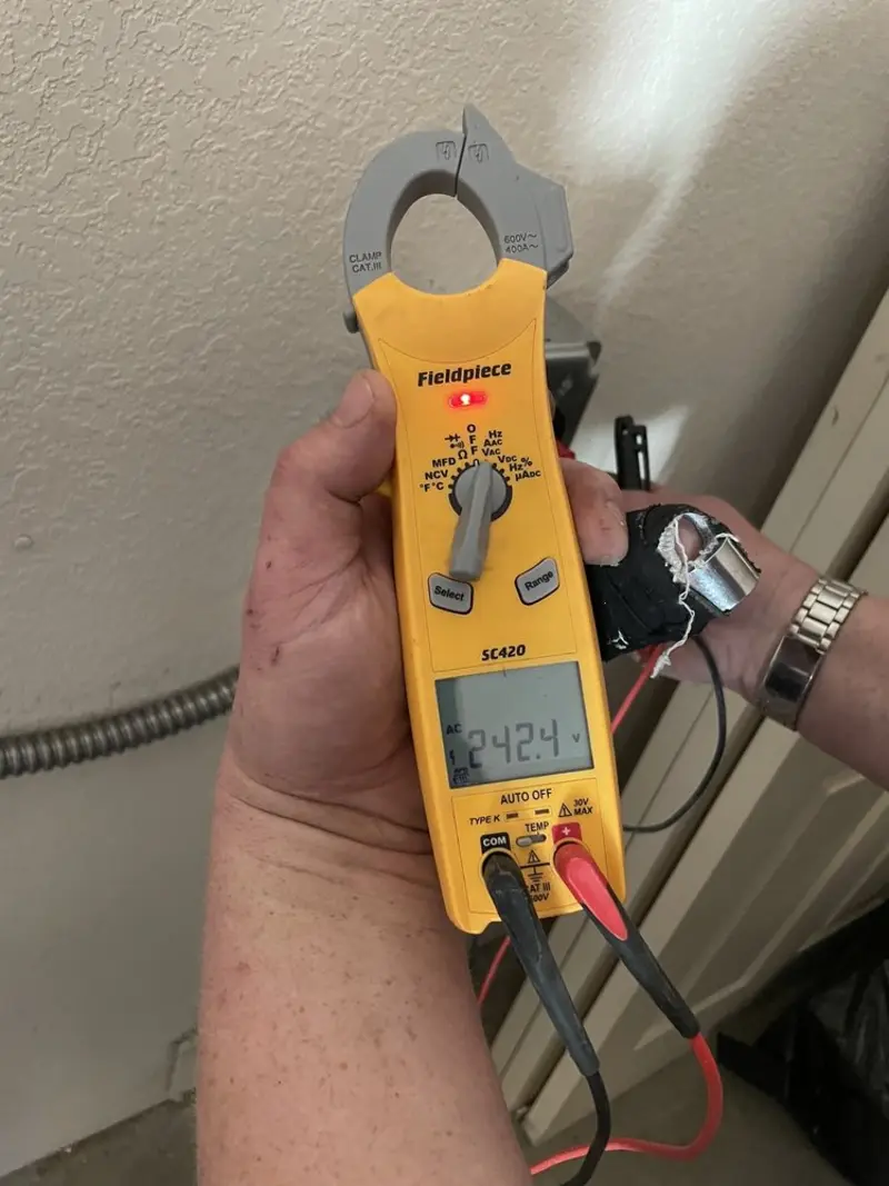 Voltage testing with clamp meter during Outlet Installation in Henrietta